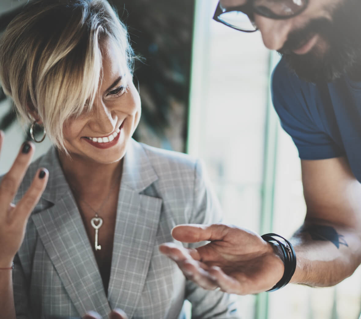 Two people talking at a desk